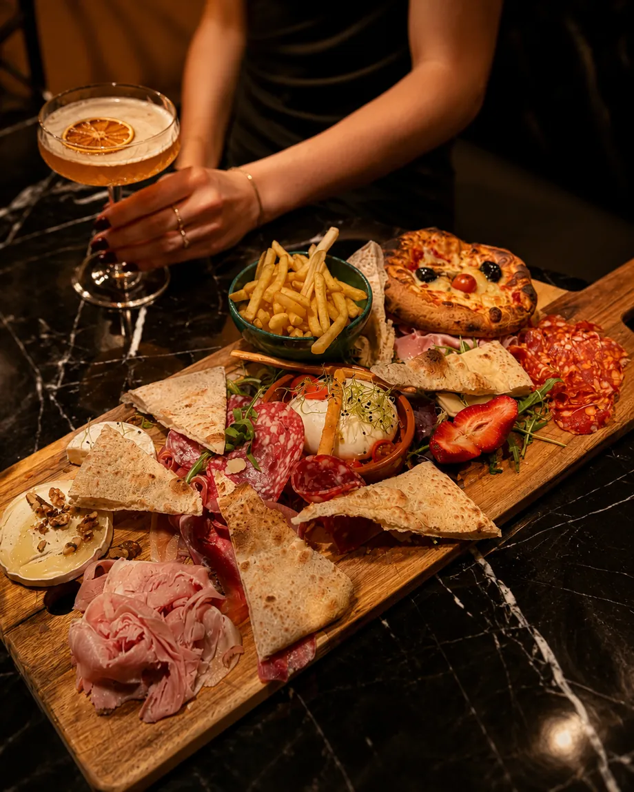 Une planche de tapas et un cocktail, servis à l'heure de l'apéritif